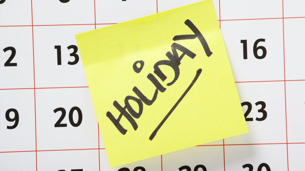 Holiday Reminder Note Stuck On A Calendar