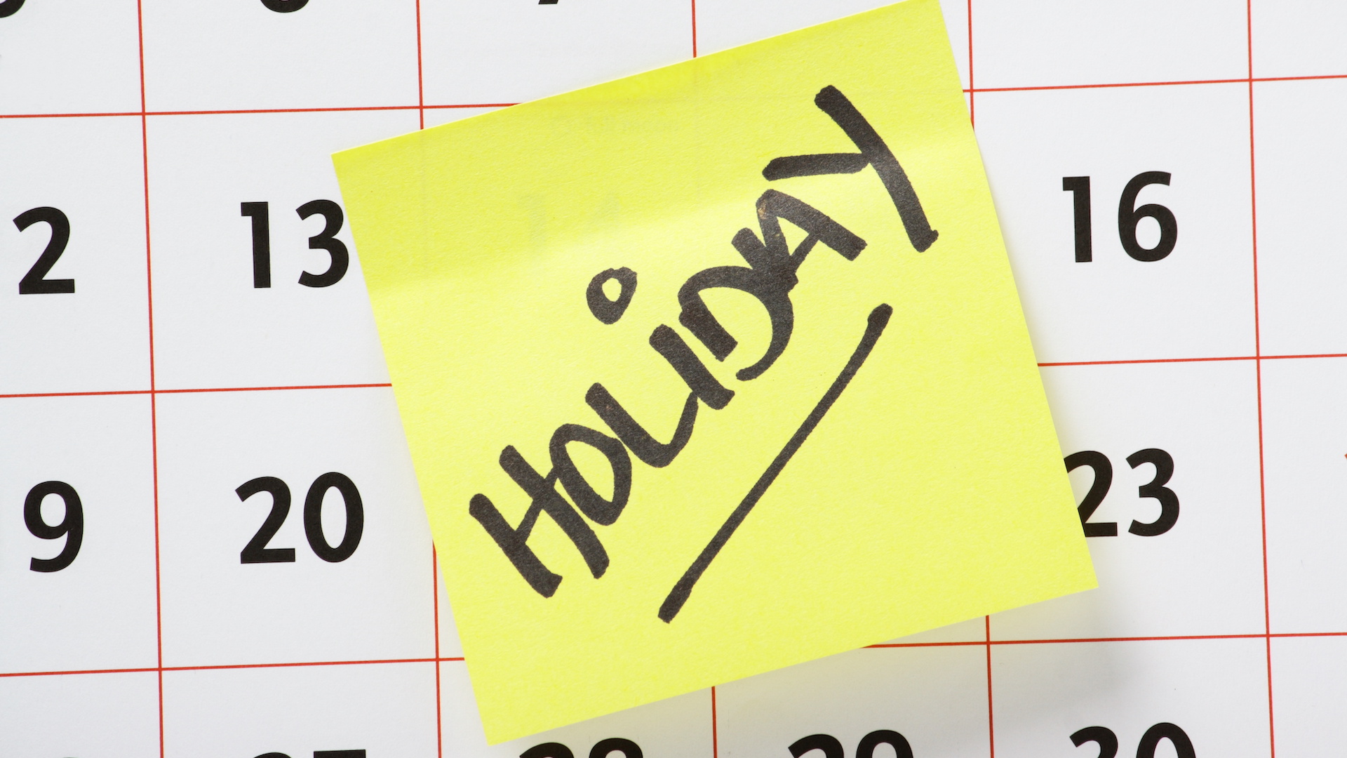 Holiday Reminder Note Stuck On A Calendar