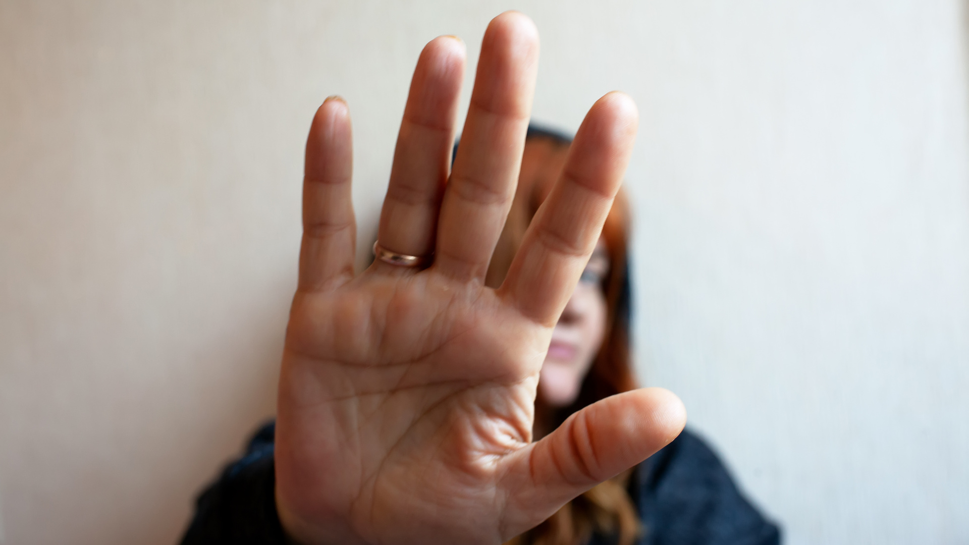 Young Woman Trying To Defend Herself With Her Hand